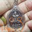 เหรียญหลวงปู่ดู่ พิมพ์เปิดโลก วัดถ้ำเมืองนะ ปี 2556 เนื้อทองแดงรมดำ มีรอยจารหน้า2ตัว จากหลวงตาม้าเมตตาจารให้ เลี่ยมกรอบเดิมจากวัด พร้อมประคำนิ้ว+คาถาบูชา